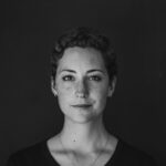 grayscale photo of woman wearing necklace and top